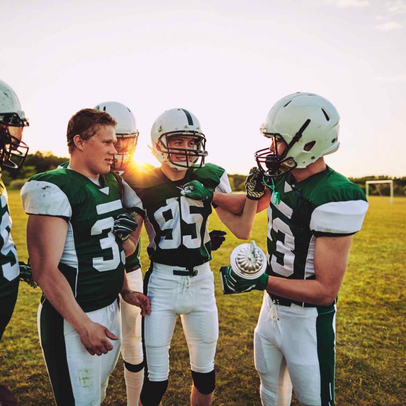 young-american-football-team-standing-together-wit-EDPLKQA.jpg